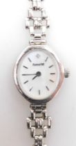 An Accurist 9ct white gold lady's wristwatch, with oval silvered colour dial set with tiny diamond,