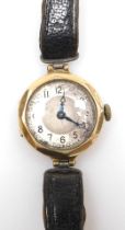 A 9ct gold cased wristwatch, the small circular watch head, with a silvered dial and blue hands, wit