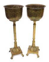 A pair of late 19thC fern pot stands, the bowl top with pitted and pleated design, on stem, with paw