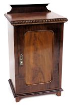 A Victorian style mahogany pot cupboard, with a panelled door, enclosing a single shelf, raised on b