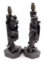 A pair of late 19th/early 20thC oriental carved hardwood lamp bases, each decorated in the form of a