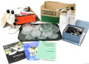 A compound microscope case, microscope, petri dishes, assorted tools, cased, syringes, liquids and m