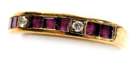 A 9ct gold, ruby and diamond half hoop eternity ring, set with seven square cut rubies, and two bril