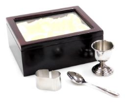 A stainless steel breakfast set, presentation cased, comprising egg cup and spoon and a napkin ring,