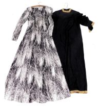 A vintage lady's evening gown, in black and white floral pattern, and a further evening dress in bla