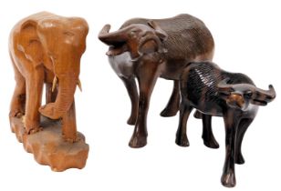 Three heavily carved 20thC wooden tribal figures, comprising standing elephant, 25cm high, bison wit