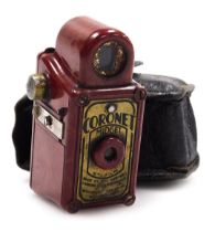 A Coronet Midget camera, with a red and orange faux marble bakelite casing, with a leather sheath, 6