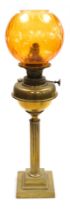 A Young's brass oil lamp, converted to electricity, of fluted column form, raised on a stepped squar