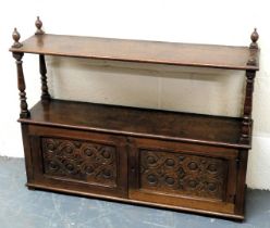 A Victorian oak wall hanging cupboard, with a shelf top raised on turned supports, above a pair of s