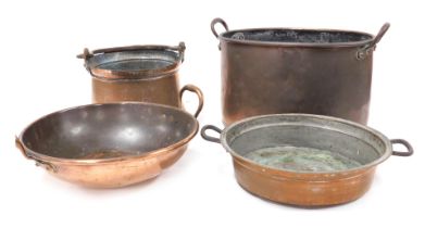 A Victorian copper twin handled oval cooking pot, copper jam pan, further cooking pot and pan. (4)