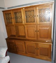 A oak display cabinet, with gallery back, leaded windows, two doors over a base unit of four doors,