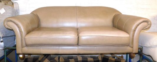 A tan leather upholstered two seater sofa.