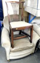 A green upholstered armchair and a single dining chair.