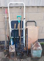 Garden items, metal jerry can, rake, fork, hoe, a pair of step ladders, etc.