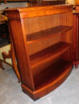 A mahogany bow fronted open bookcase of three shelves.