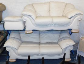 A two piece leather suite, upholstered in cream, one two seater and one three seater.