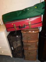 A luggage trunk, two suitcases and two camping chairs.