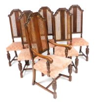 A set of six early 20thC oak dining chairs, each with a caned high back red and cream upholstered pa