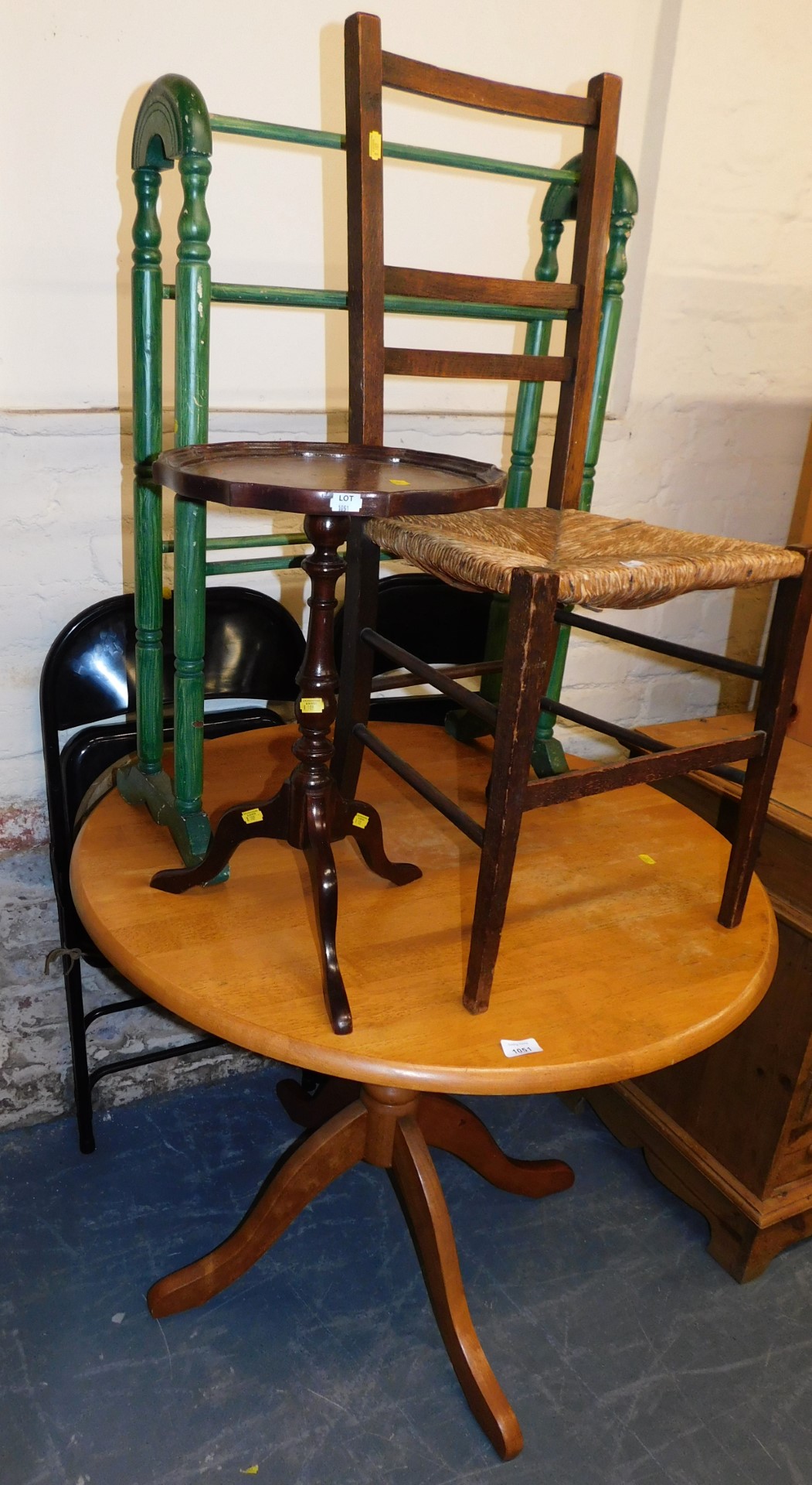 A circular pine kitchen table, a chair with rush seat, small occasional table, towel rail and two me