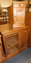 A small pine pot cupboard and pine unit, with glazed door to one side, drawer and door below on the