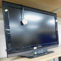 A Sharp 32 inch flat screen television, model no. LC-32SH7E-BK.
