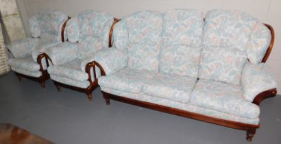 A three piece suite, with wooden frame and floral upholstery, comprising of a two seater settee and