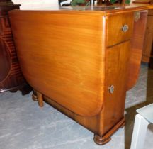 A 1950's drop leaf dining table, with drawer to one end, cupboard door below.
