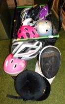 Various cycle helmets and a fencing helmet.