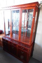 A display cabinet, with three glazed doors to the top, above three drawers and three cupboard doors,