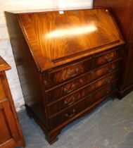 A mahogany veneered full front bureau, fall over two short drawers above three long drawers, raised