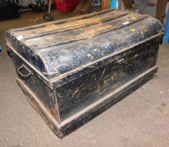 A black metal tin trunk.