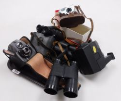 Two pairs of binoculars, cameras including a Polaroid and a Pal Mat EE.