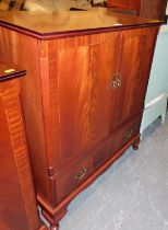 A mahogany lined and inlaid TV unit with two folding doors to front above single drawer on shaped ap