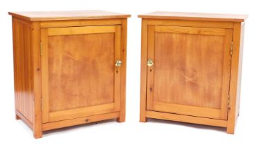 A pair of pine bedside cabinets, each rectangular top above a panelled door enclosing single shelf,