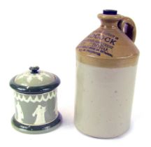 An L Adcock Peterborough stoneware flagon, 29cm high, together with a HW and R pottery tobacco jar a