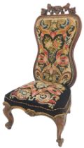 A Victorian nursing chair, with Berlin wool work upholstery.