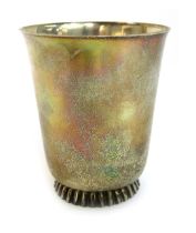 A Wilkens white metal drinking cup, of plain design on a fluted base, marked Wilkens 835, 9cm high,