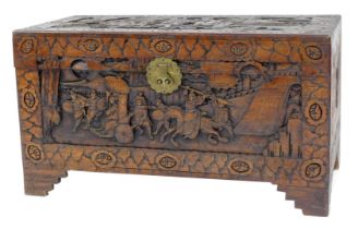 An Oriental camphor wood chest, carved with figures, floral motifs, etc., on carved bracket feet, 54