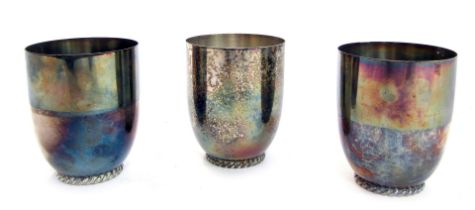 Three Wilkens white metal drinking cup, of plain design on reeded base, marked Wilkens 835, 9cm high