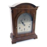 A Thwaites & Reed of Clerkenwell of London walnut cased mantel clock, with a silvered Romanic numeri