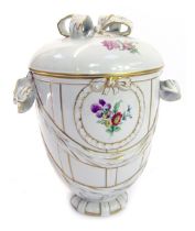A KPM Berlin porcelain jar and cover, on a cream ground decorated with ribbons, bows and floral spra
