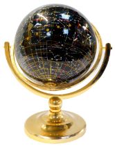 A Nightsky black agate celestial globe, set with mother of pearl, on a brass stand, 36cm high.