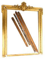 A 19thC giltwood frame, the top surmounted by a scroll and leaf carved section, the frame decorated