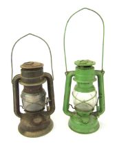 A Czechoslovakian green painted paraffin lamp, numbered 863, 25cm high, and another similar, 24cm hi