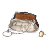 A Victorian or Edwardian silver coin purse, enclosing a brown leather concertina section, with