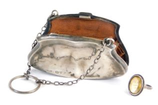 A Victorian or Edwardian silver coin purse, enclosing a brown leather concertina section, with