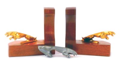 A pair of 20thC oak Jaguar car L shaped bookends, each mounted with a brass cast metal figure of a j