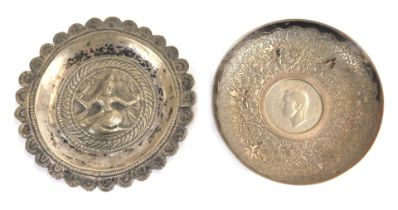 An Indian white metal trinket dish, of circular form engraved with leaf motif decoration, inset cent