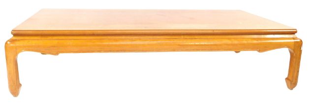 An Oriental influence beech low occasional table, the rectangular top with a moulded edge above a sh