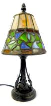 A Tiffany style table lamp, the leaded glass shade of tapering circular form, decorated in green, bl